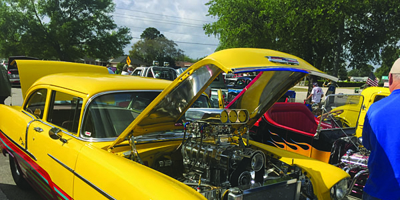 yellow car with hood open